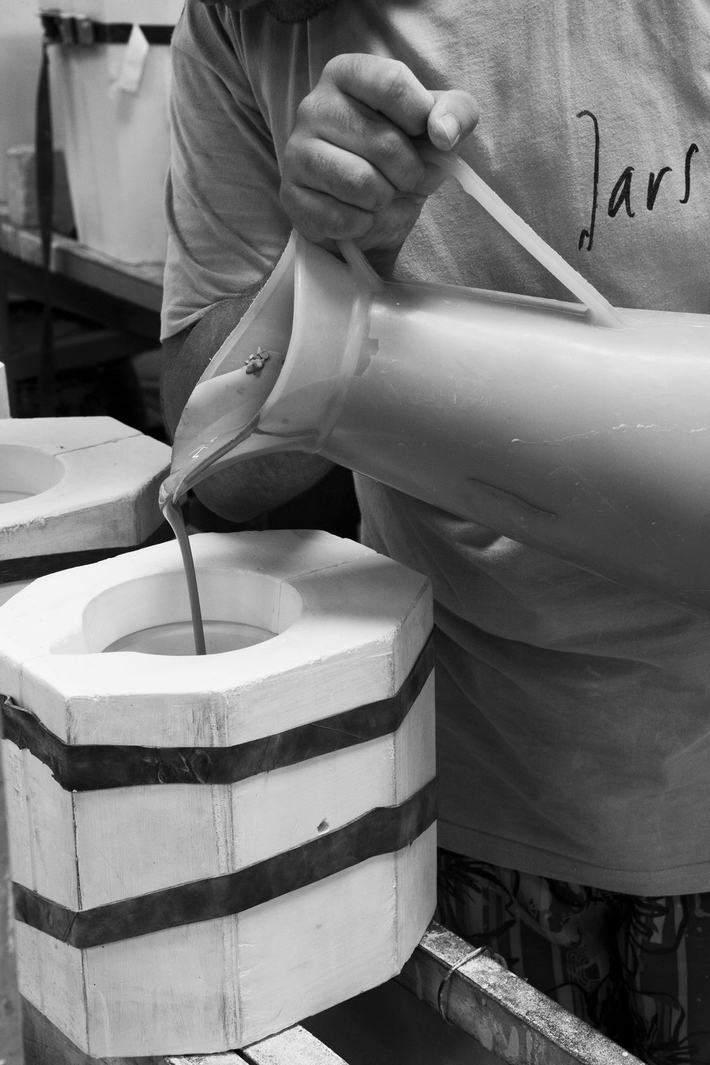 A person pouring liquid into a container