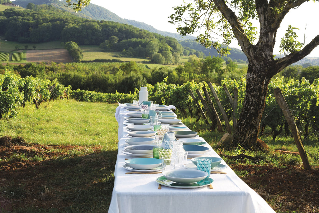 Long table with plates and plates on it