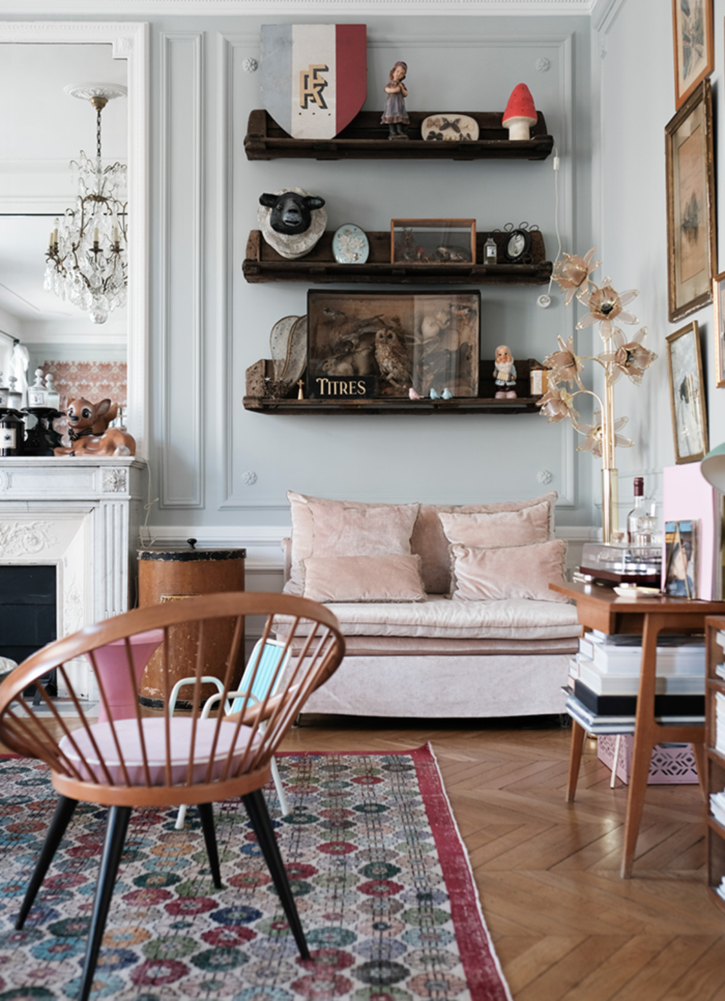 A living room with a couch and shelves on the wall.